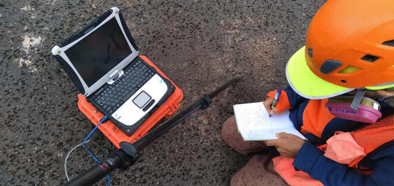 Color photograph of scientist logging data