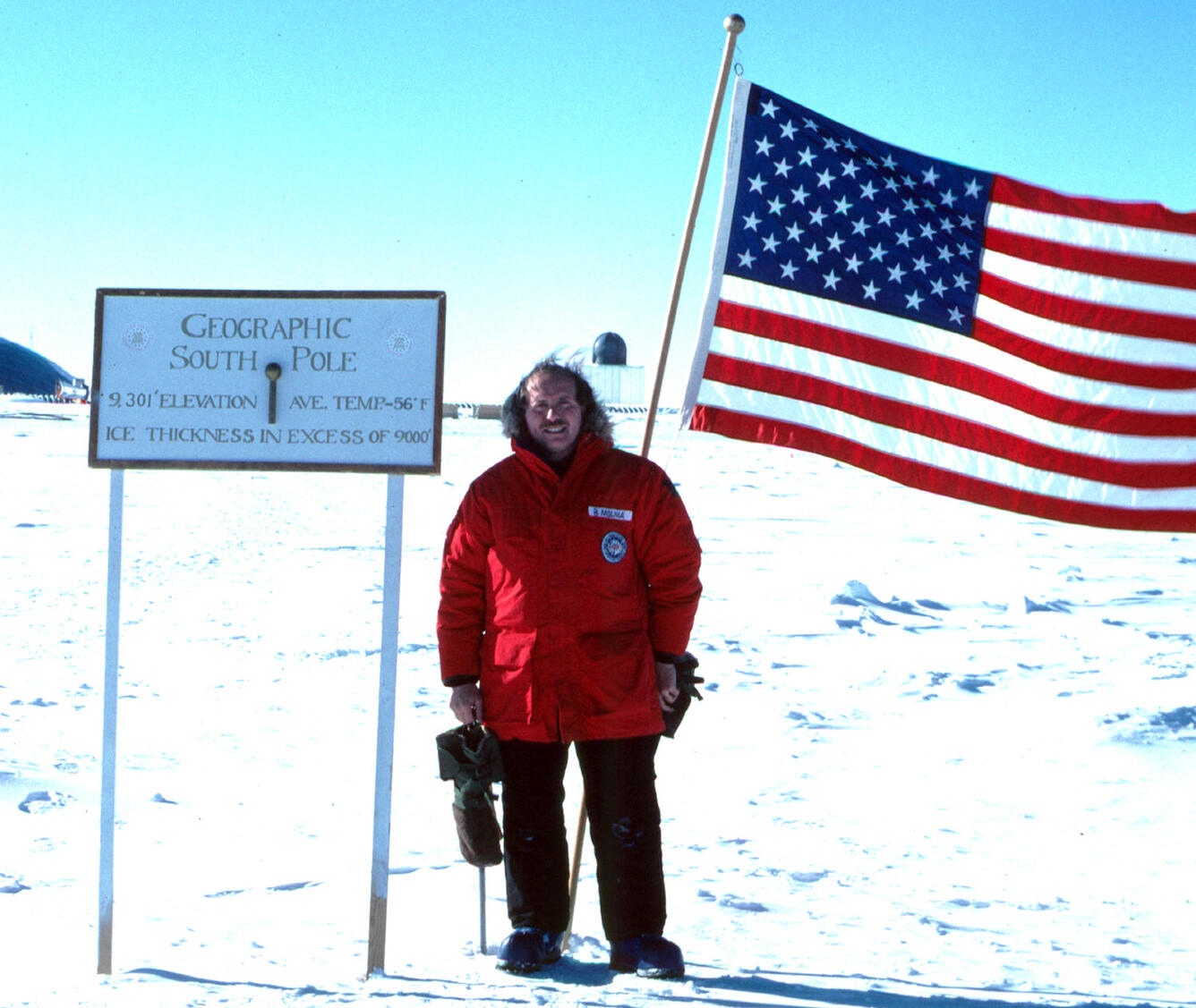 Bruce Molnia standing at the Geographic South Pole 