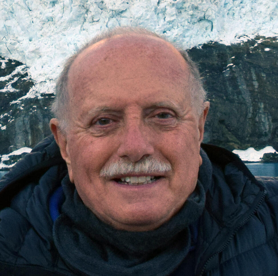 Scientist Emeritus Bruce Molnia in front of a hanging glacier in Drygalski Fjord, south end of the island of South Georgia