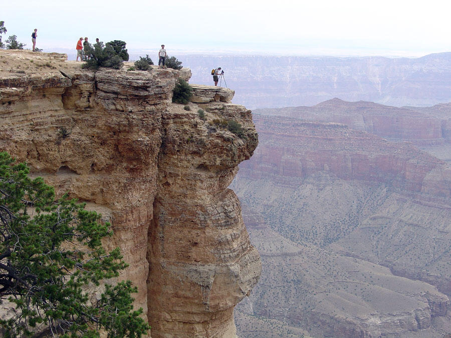 This is a photo of park visitors on the Kaibab Limestone, the rim rock of the North Rim in Grand Canyon National Park.