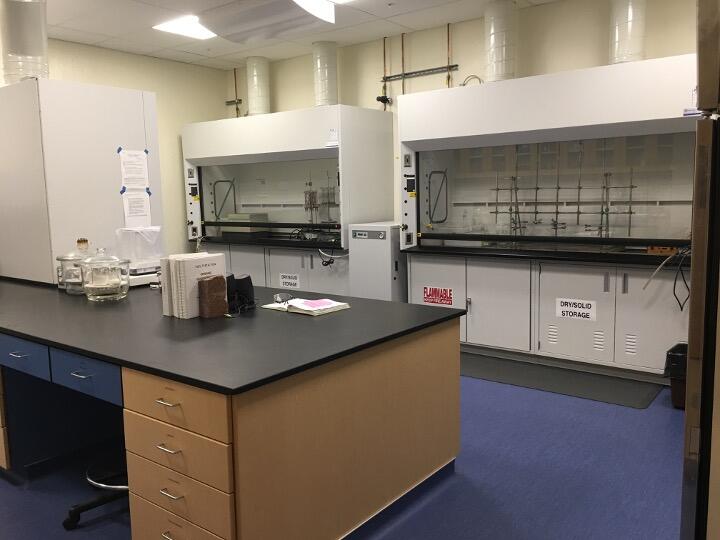 Photograph of a lab with large ventilation spaces and a workbench.