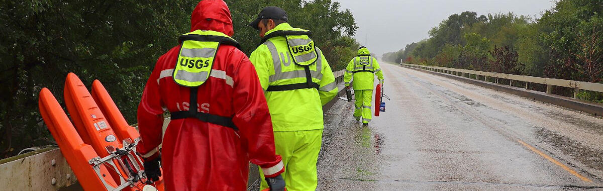 A USGS crew prepares to measure Hurricane Harvey floodwaters off of a bridge.