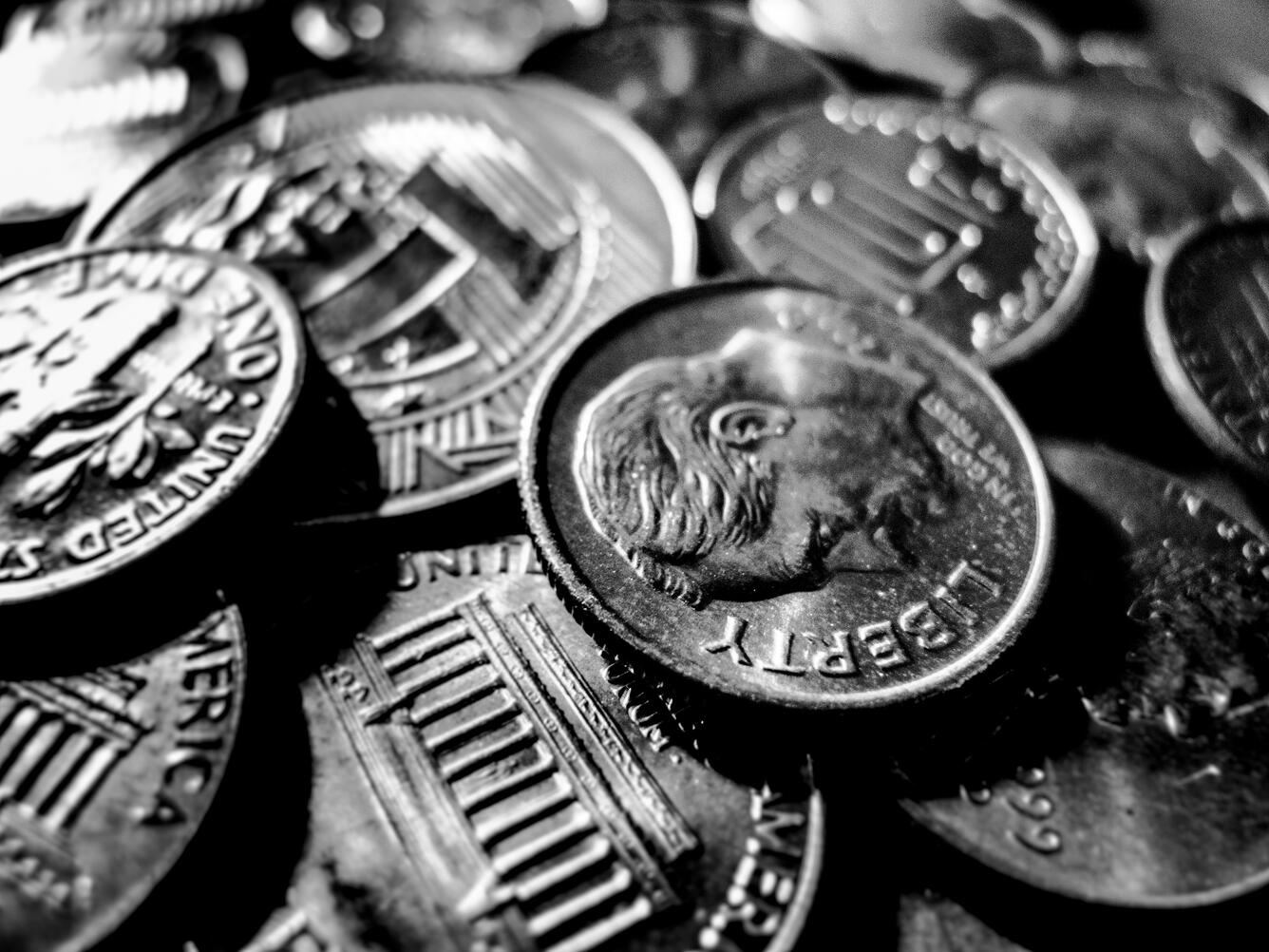 Silver coins laid on top of one another 