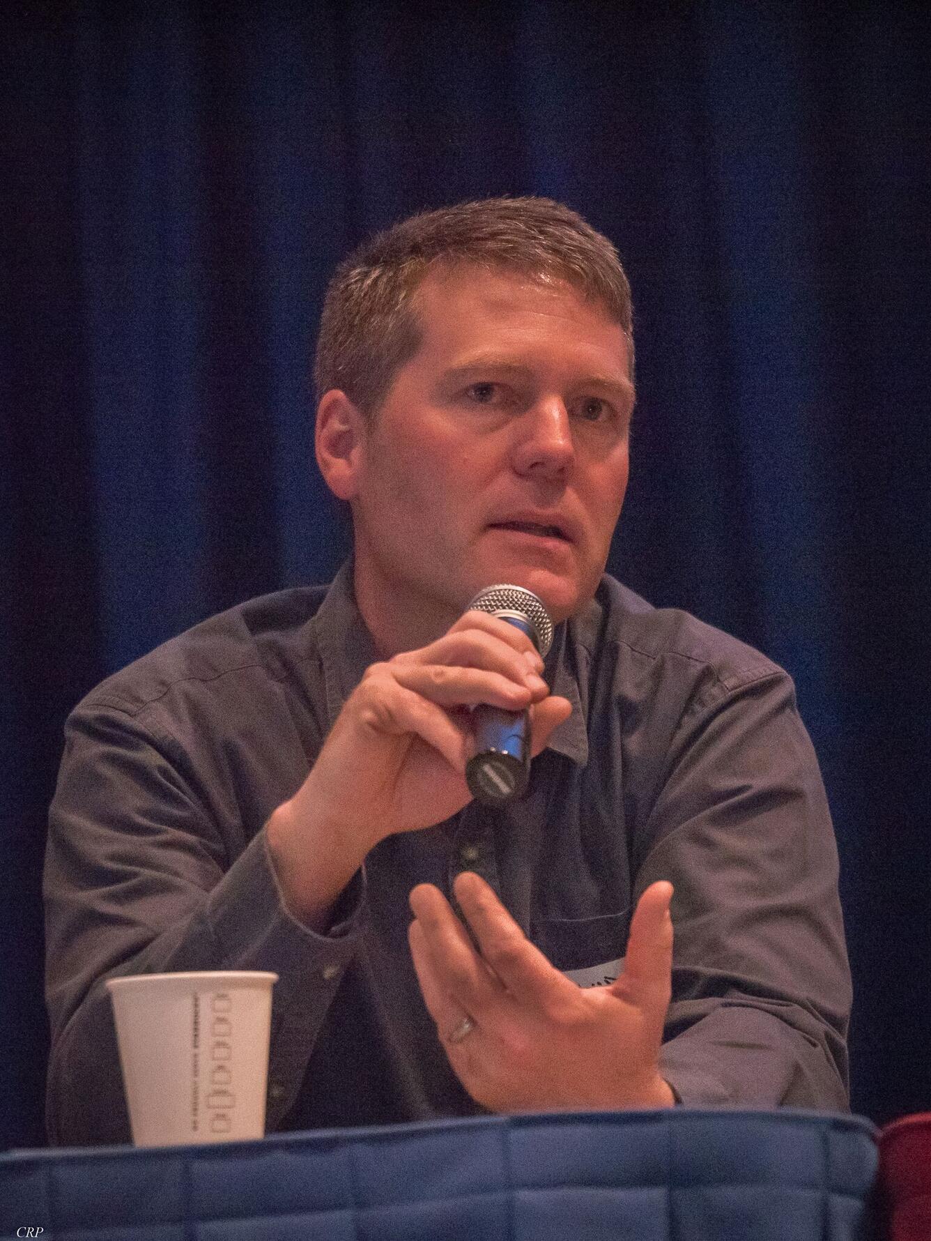 David Pilliod holding a microphone while speaking