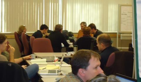 Powell Center Working Group paired in groups sitting around tables going through group exercises.