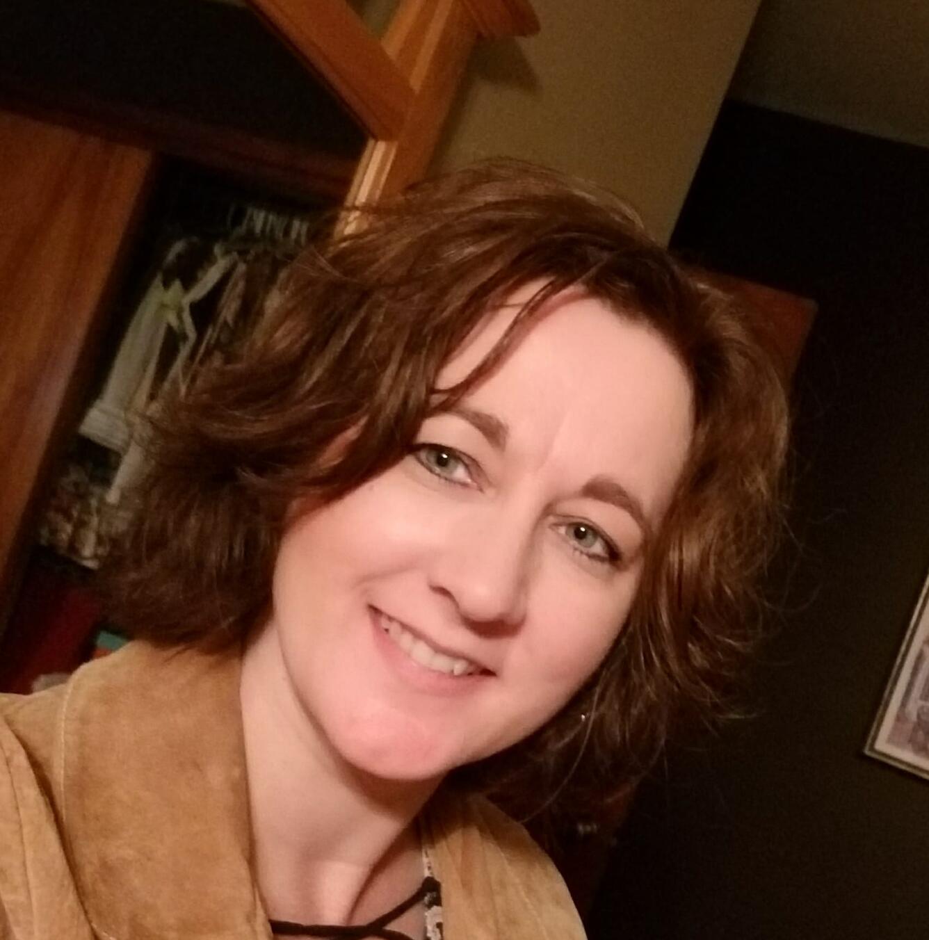 woman's profile with brown hair brown shirt