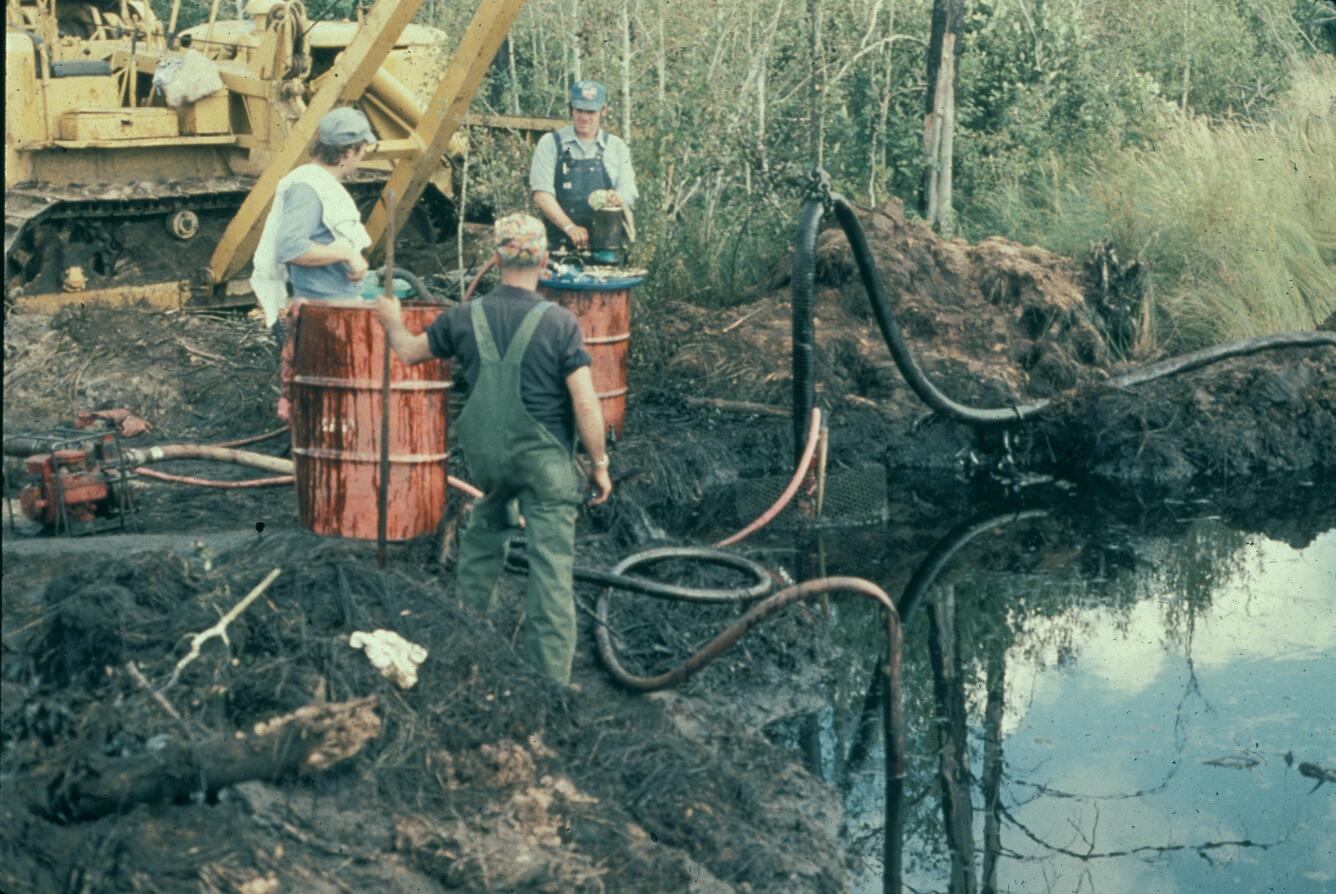 Crew removing oil from a trench dug in a wetland south of the Bemijdi crude oil pipeline break location.