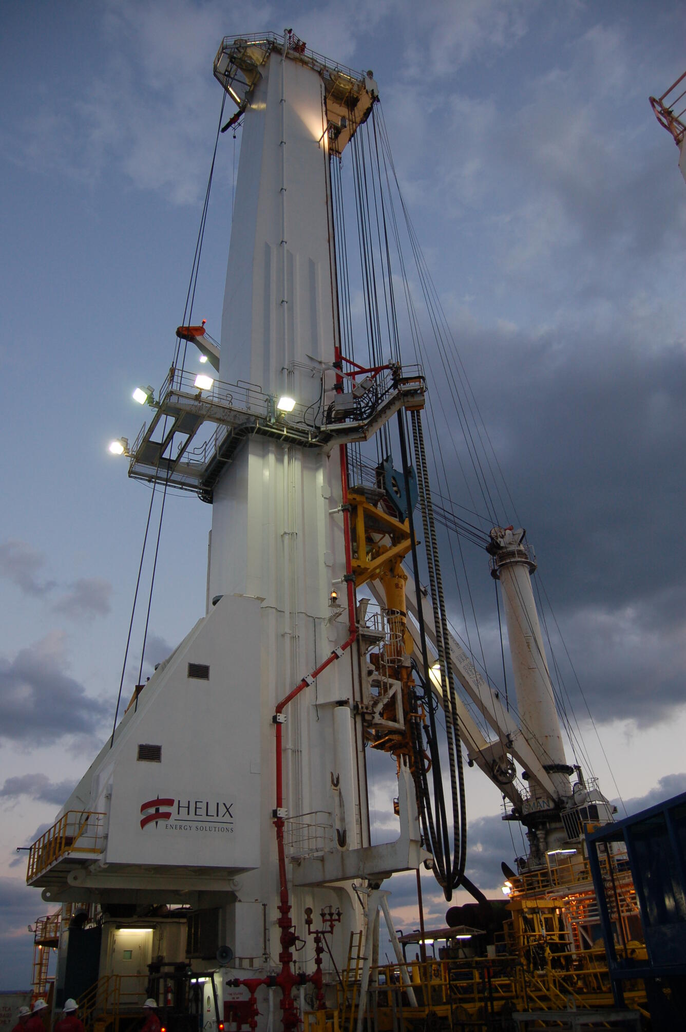 Image shows a drill rig at twilight