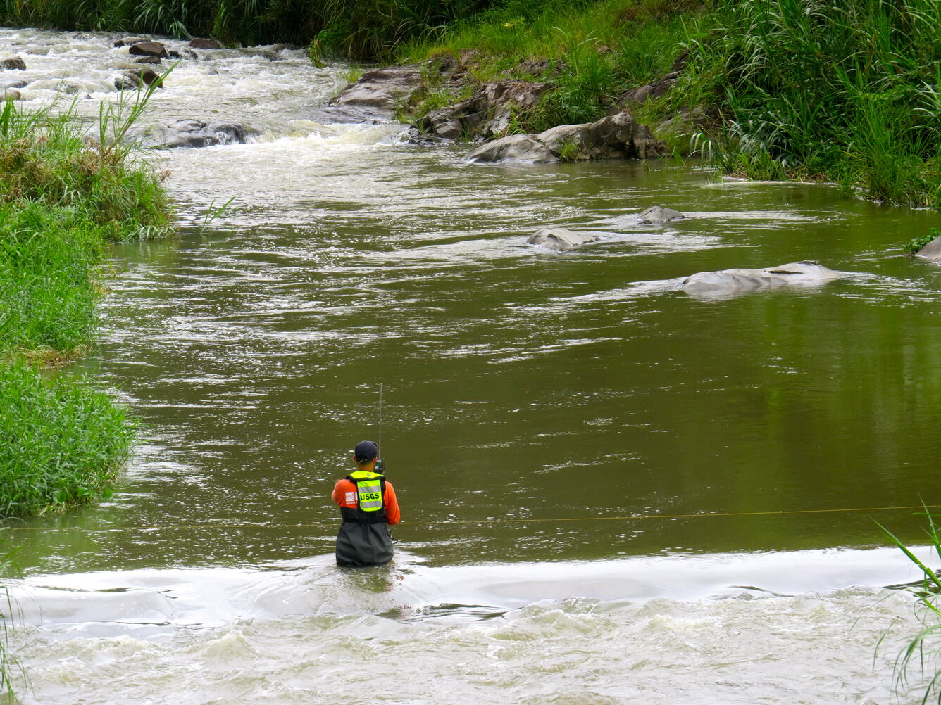 Technician making discharge measurements