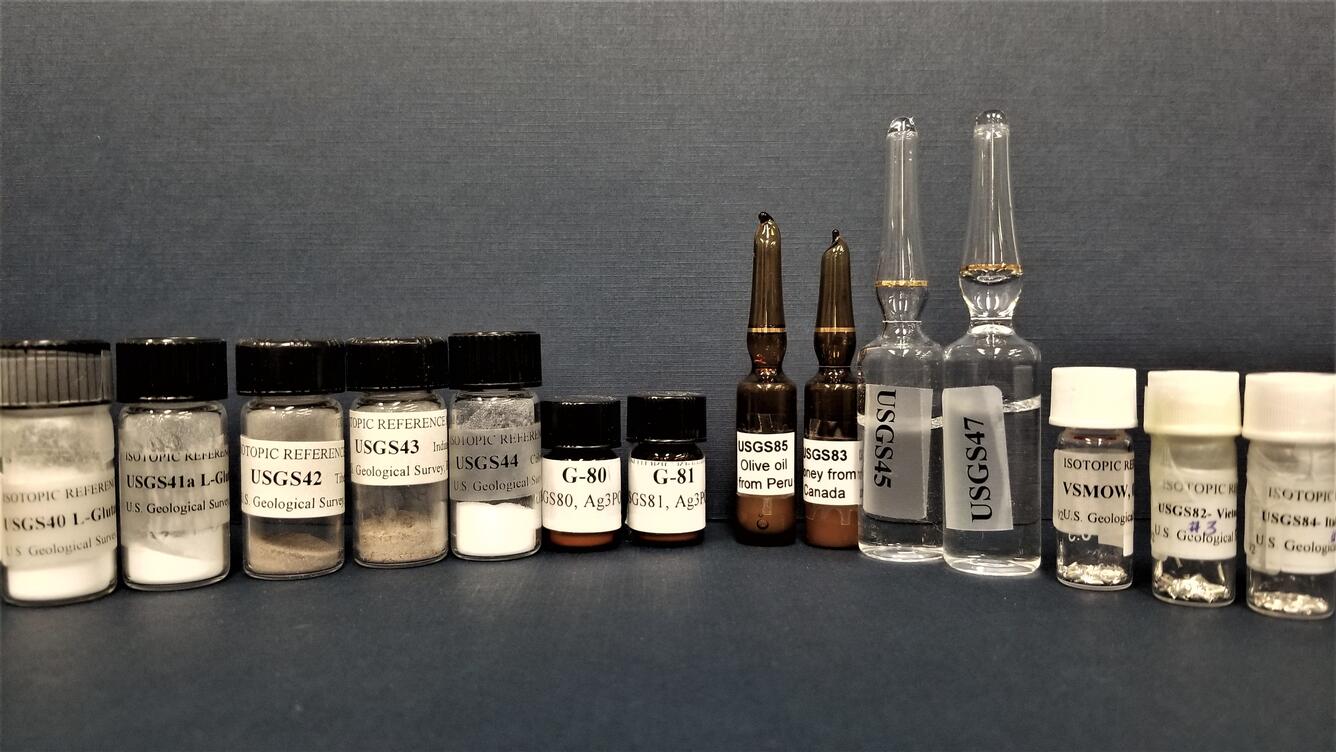 An assortment of small bottles and vials containing powders and liquids