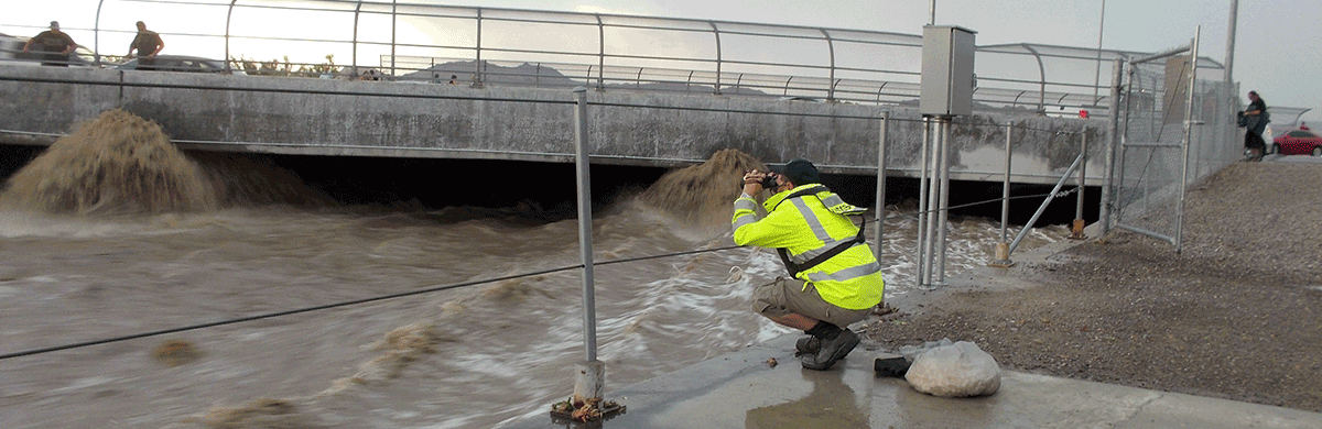 Reading the staff gage during flooding in Las Vegas, Nev.