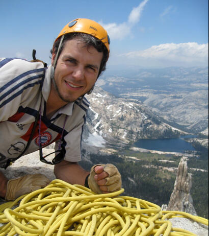 Richard Lease at the top of a mountain with climbing gear on