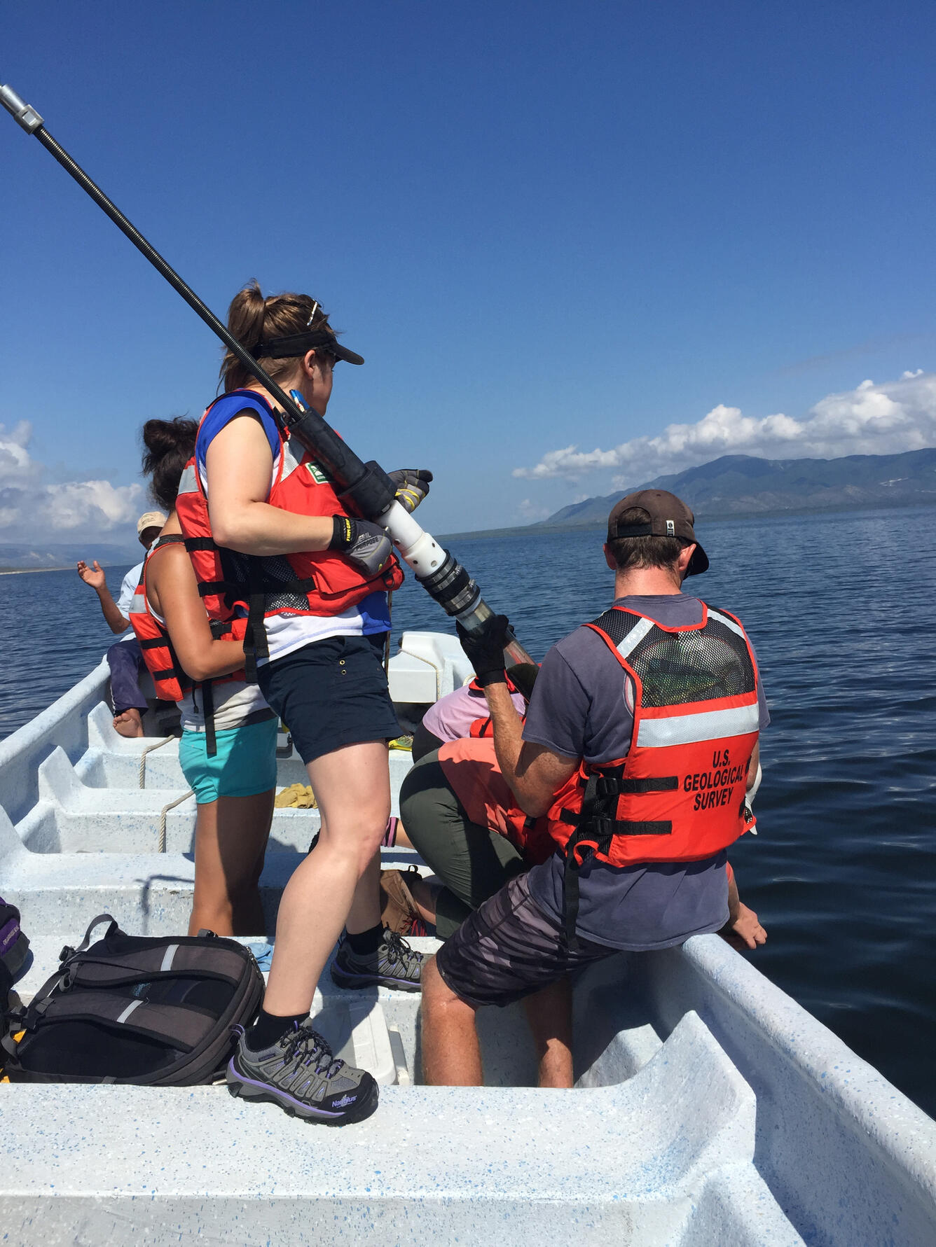 Jessica Rodysill (Reston) and Hunter Wilcox (SPCMSC) deploying a corer in Lake Enriquillo.