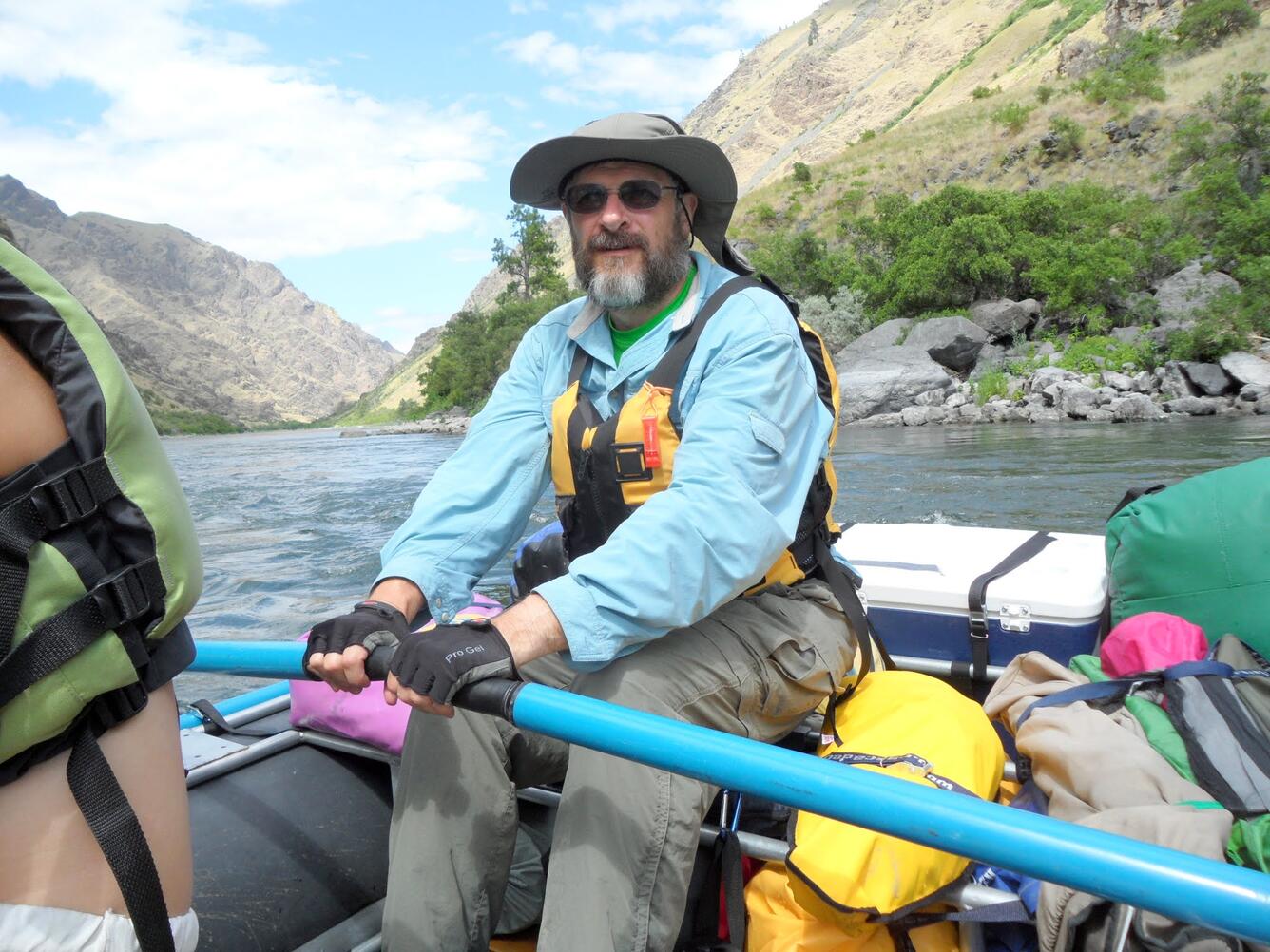 Photo of hydrologist, Alan Rea, rowing a raft in Hells Canyon