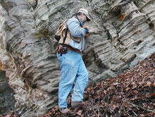 Photo of geologist examining a huge slump block of Ordovician age St. Peter Sandstone.