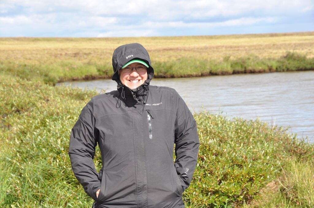 Sarah Laske standing in the tundra near a pond  on the north slope of Alaska