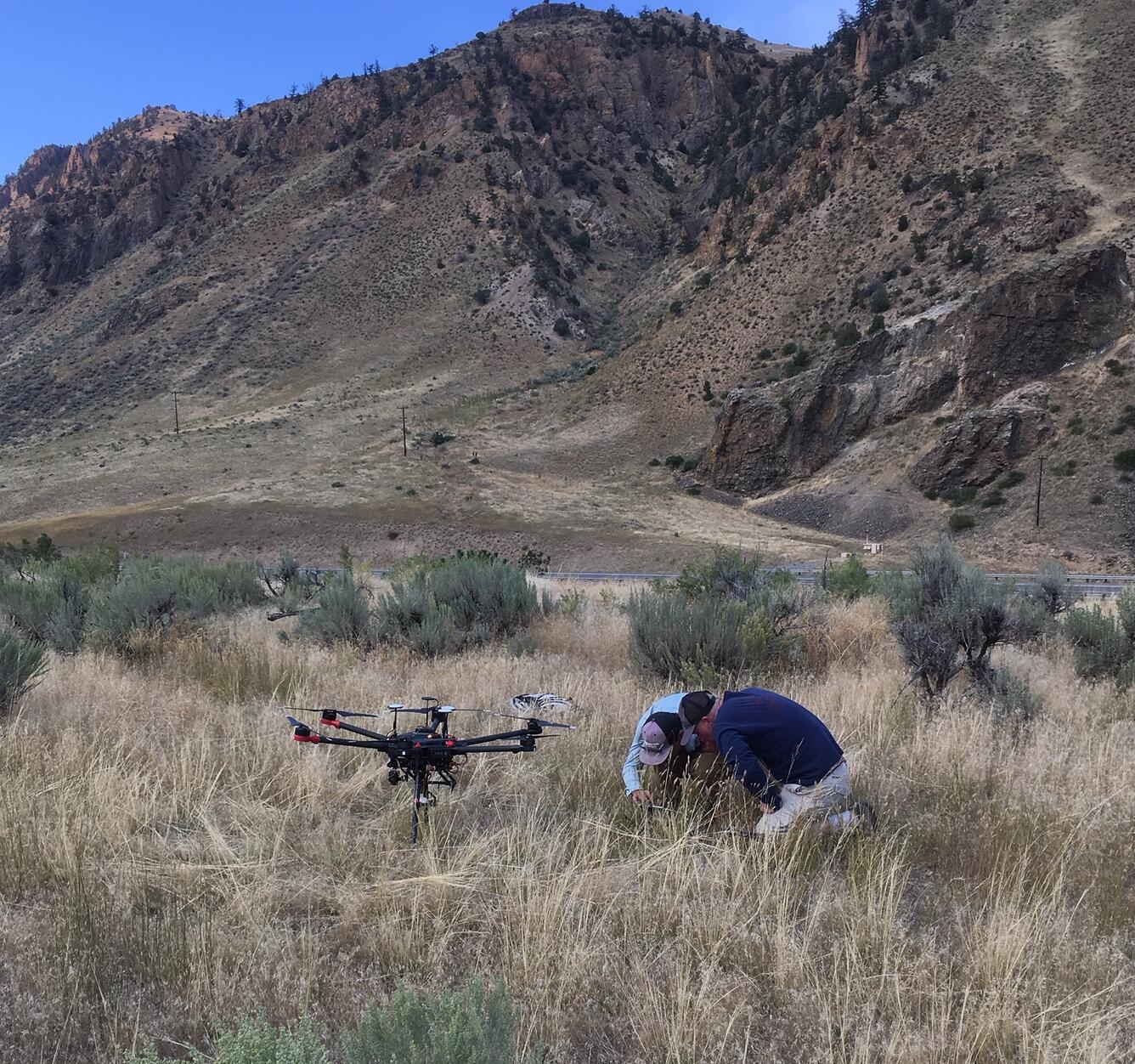 This is a photo of scientists preparing for a UAV flight on the west side of the Yellowstone River.