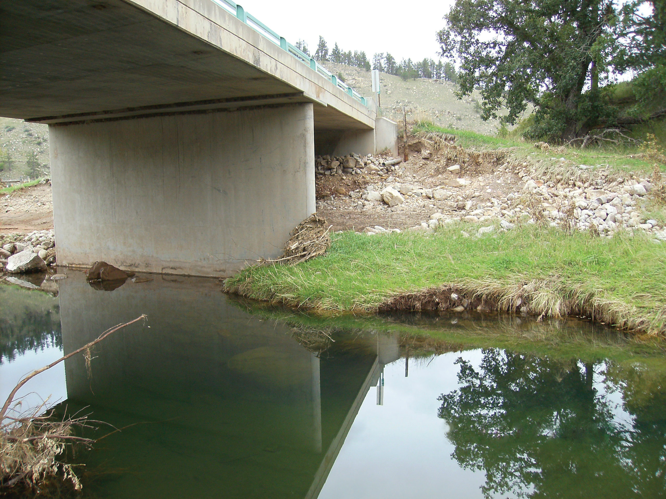 Image shows scour damage beneath a bridge