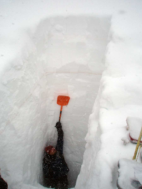 scientist in snowpack pit