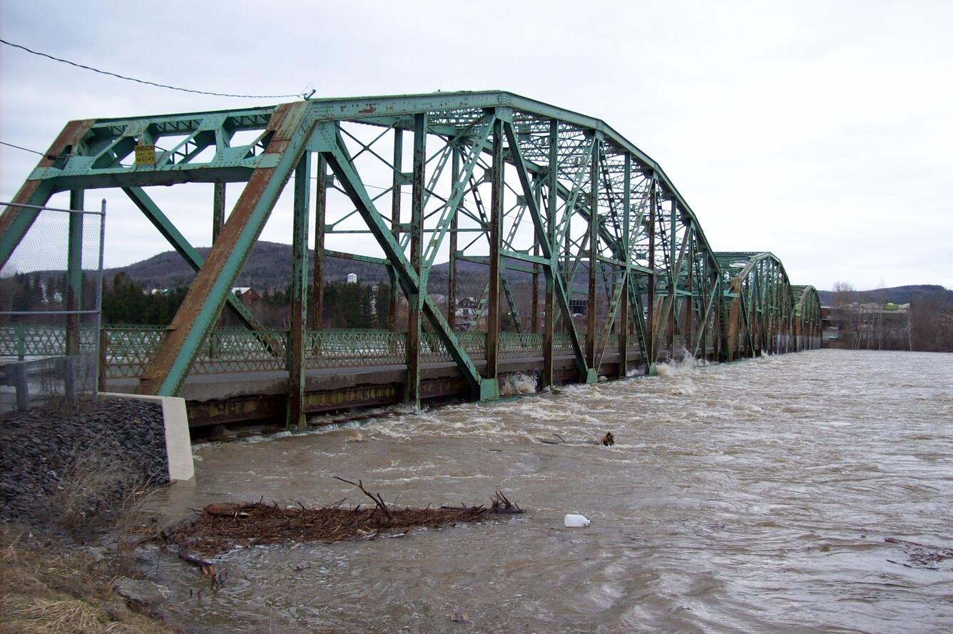 St. John River threatens to swamp a steel bridge.