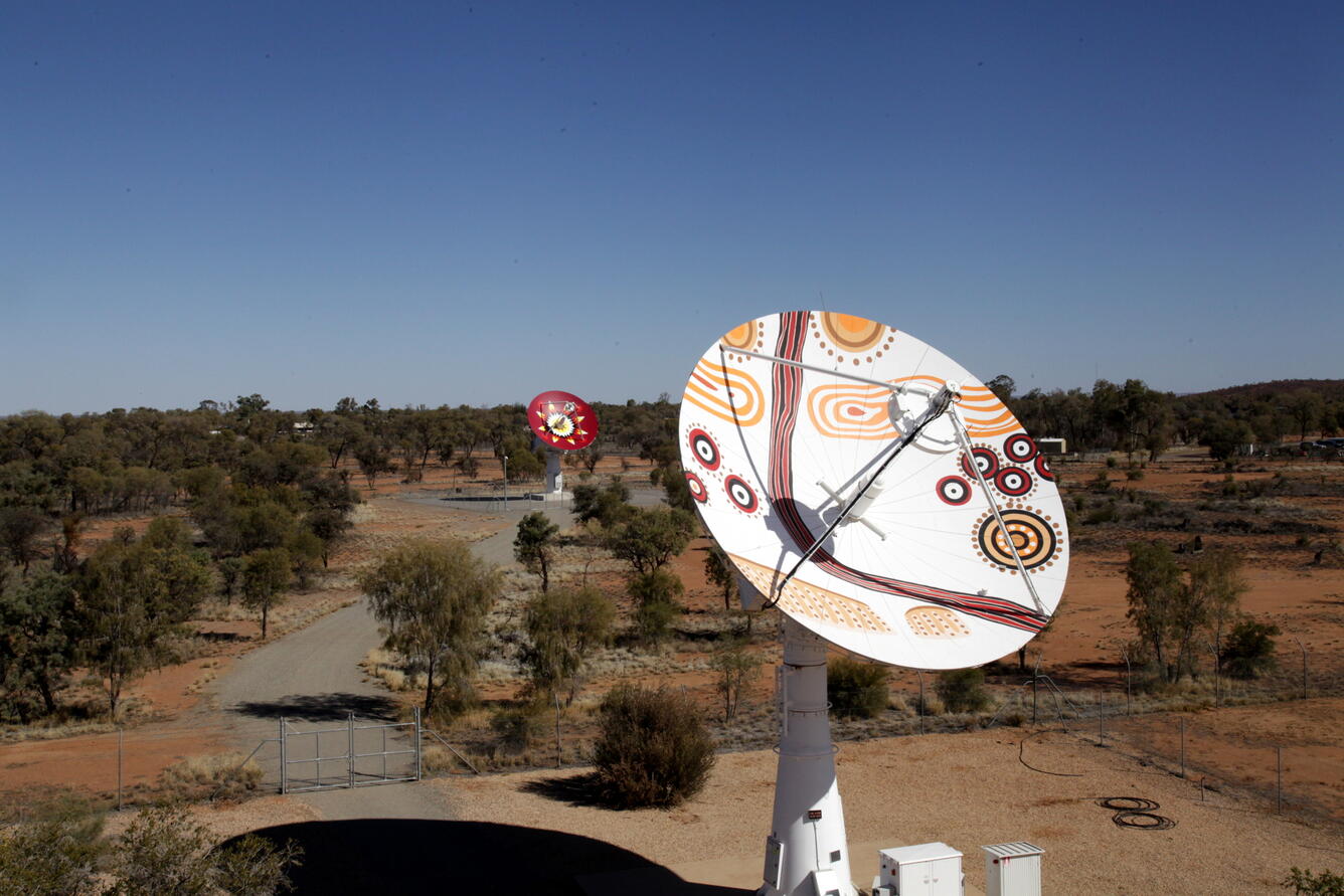 Color image of aboriginal art on two satellite dishes