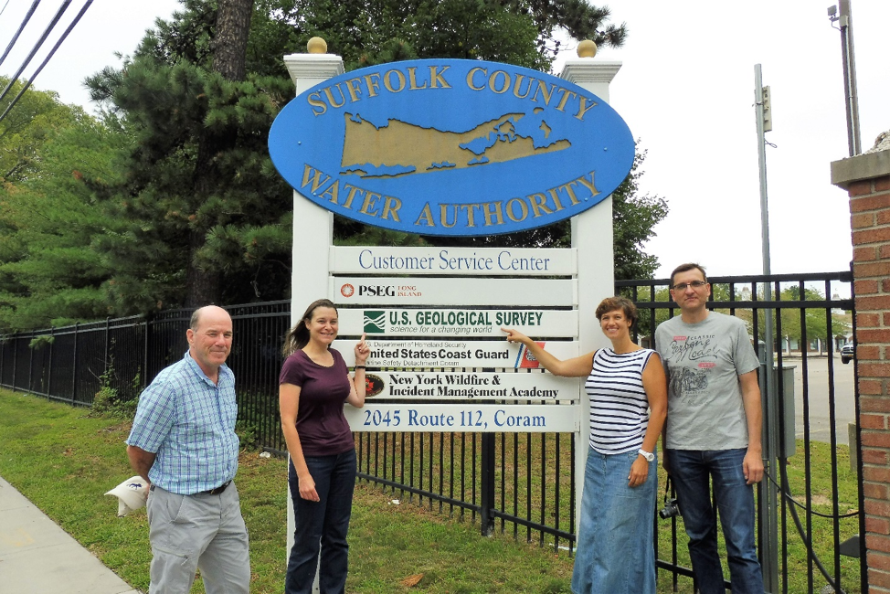 Four people standing in from of the USGS sign at the Coram, New York Office