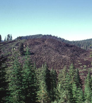 Devil's garden, the blocky lava flow in foreground, forms part of Tumble Buttes.