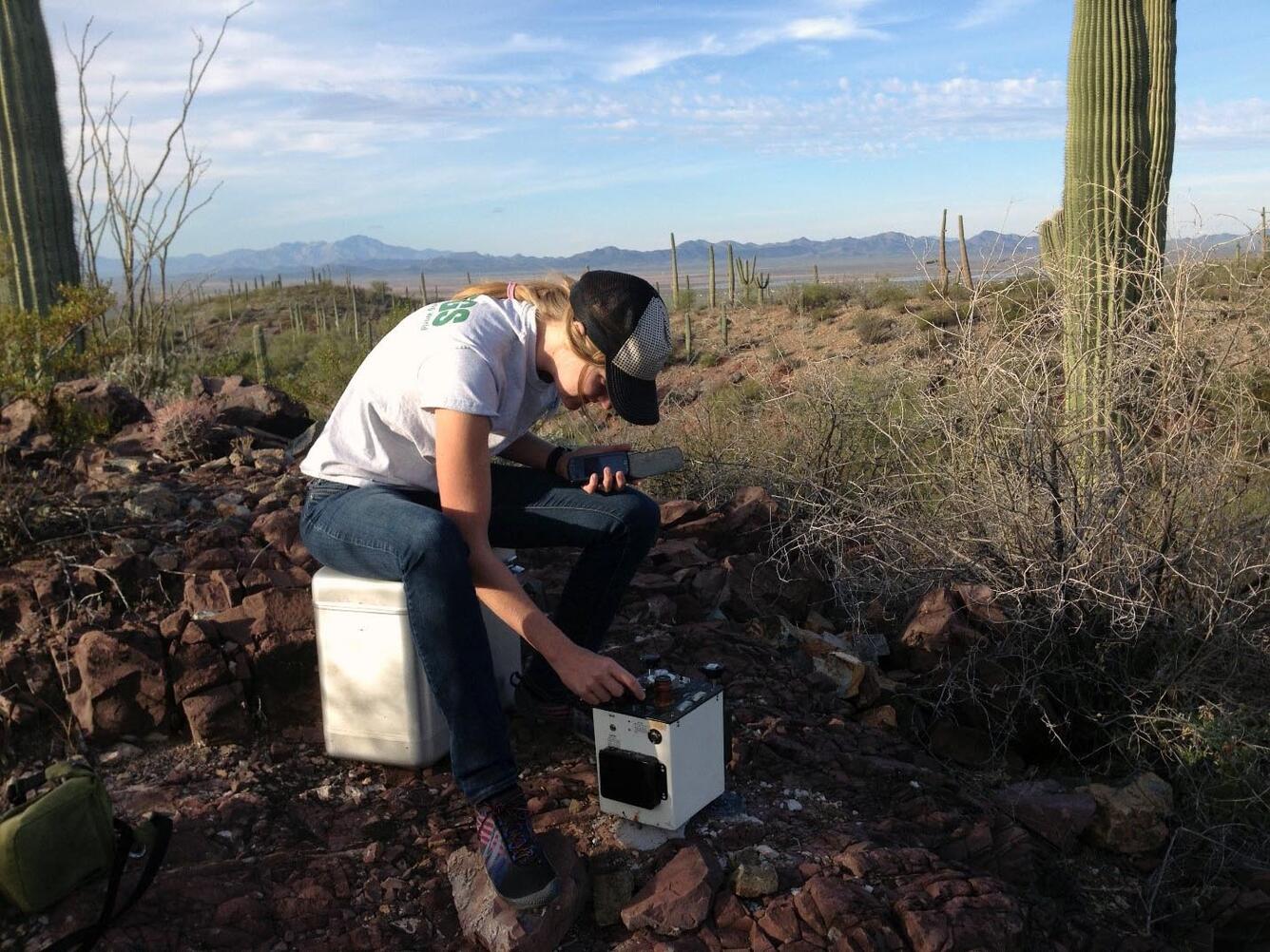 Person using meter to collect relative gravity data near Tucson, Arizona