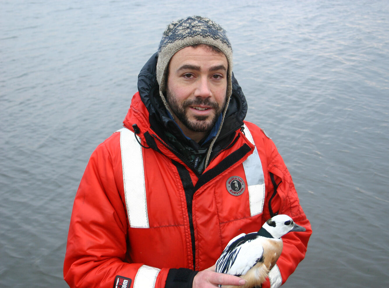 Tyler Lewis holding a Steller's Eider