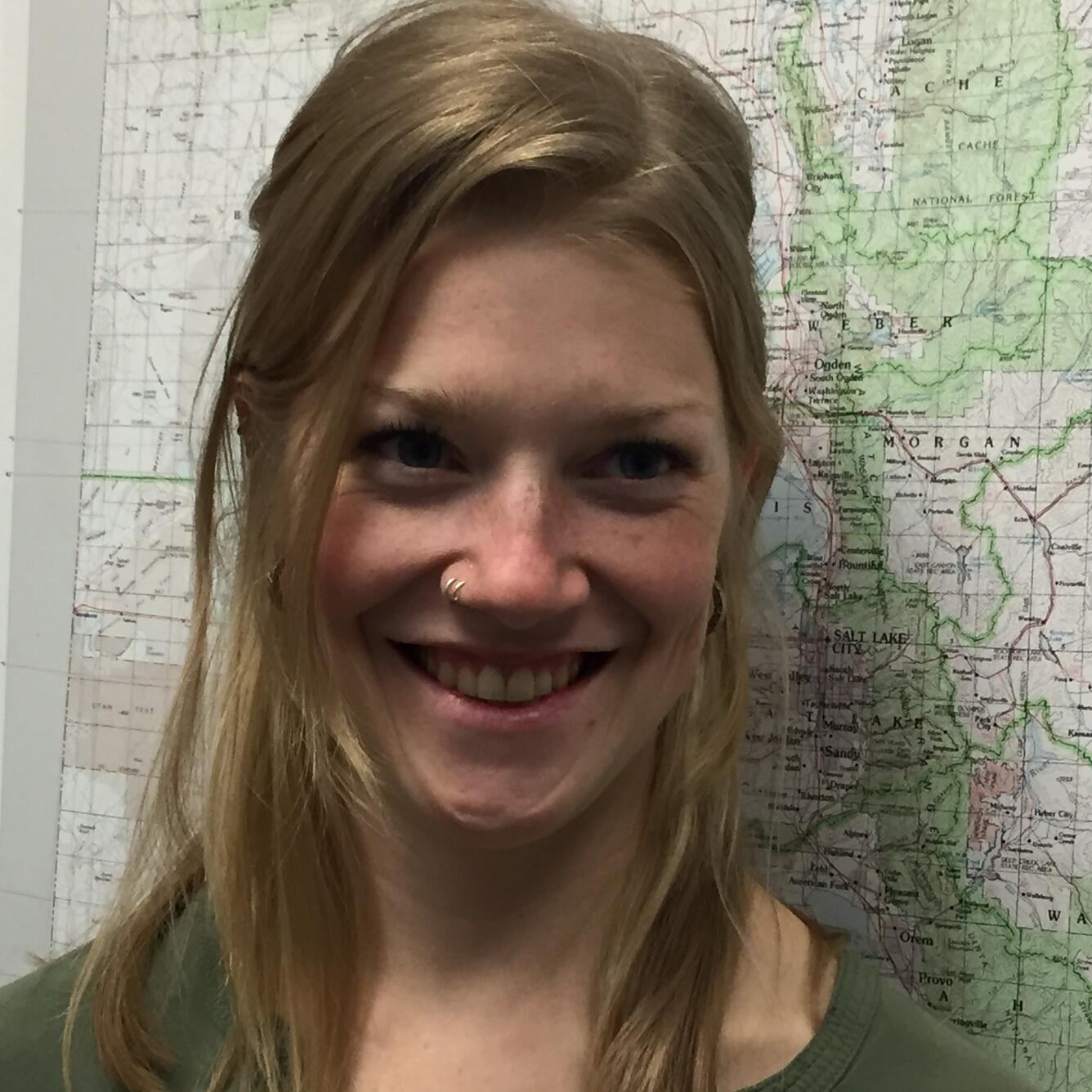 Photo of Scientist Kate Jones in front of a map of Utah