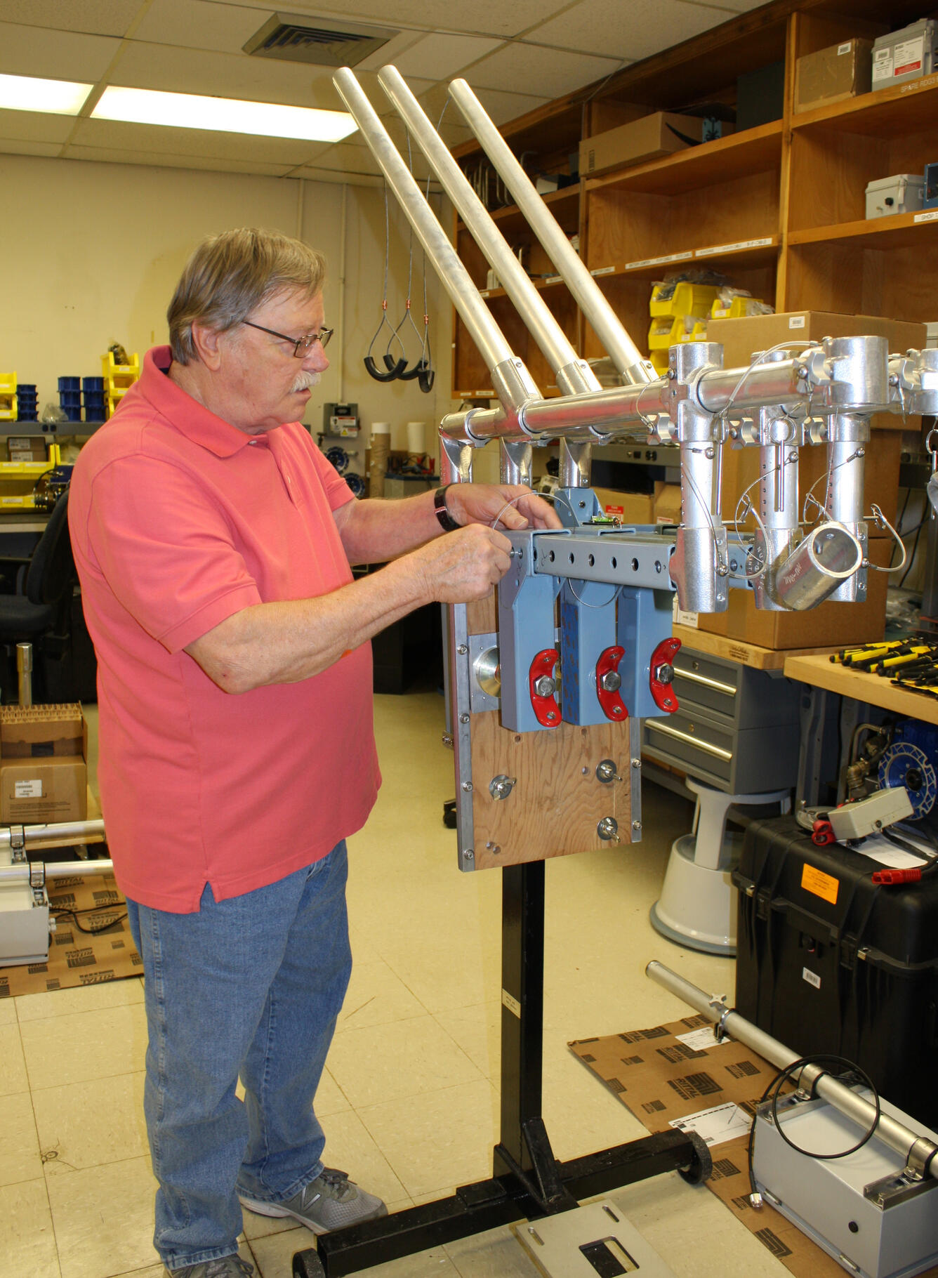 USGS electronic technician threads a wire into a rapid deployment gage assembly.