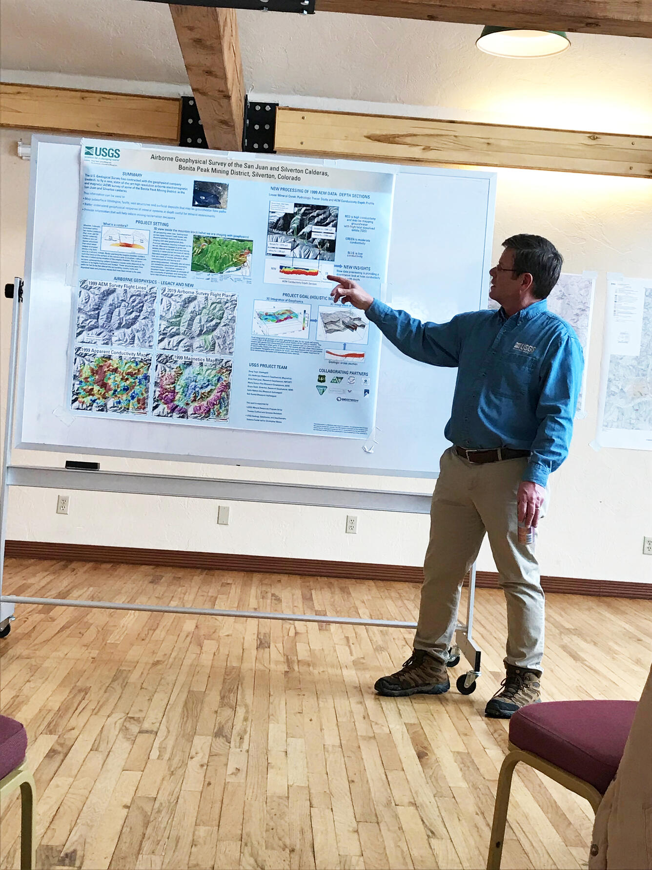 scientist pointing as poster on wall