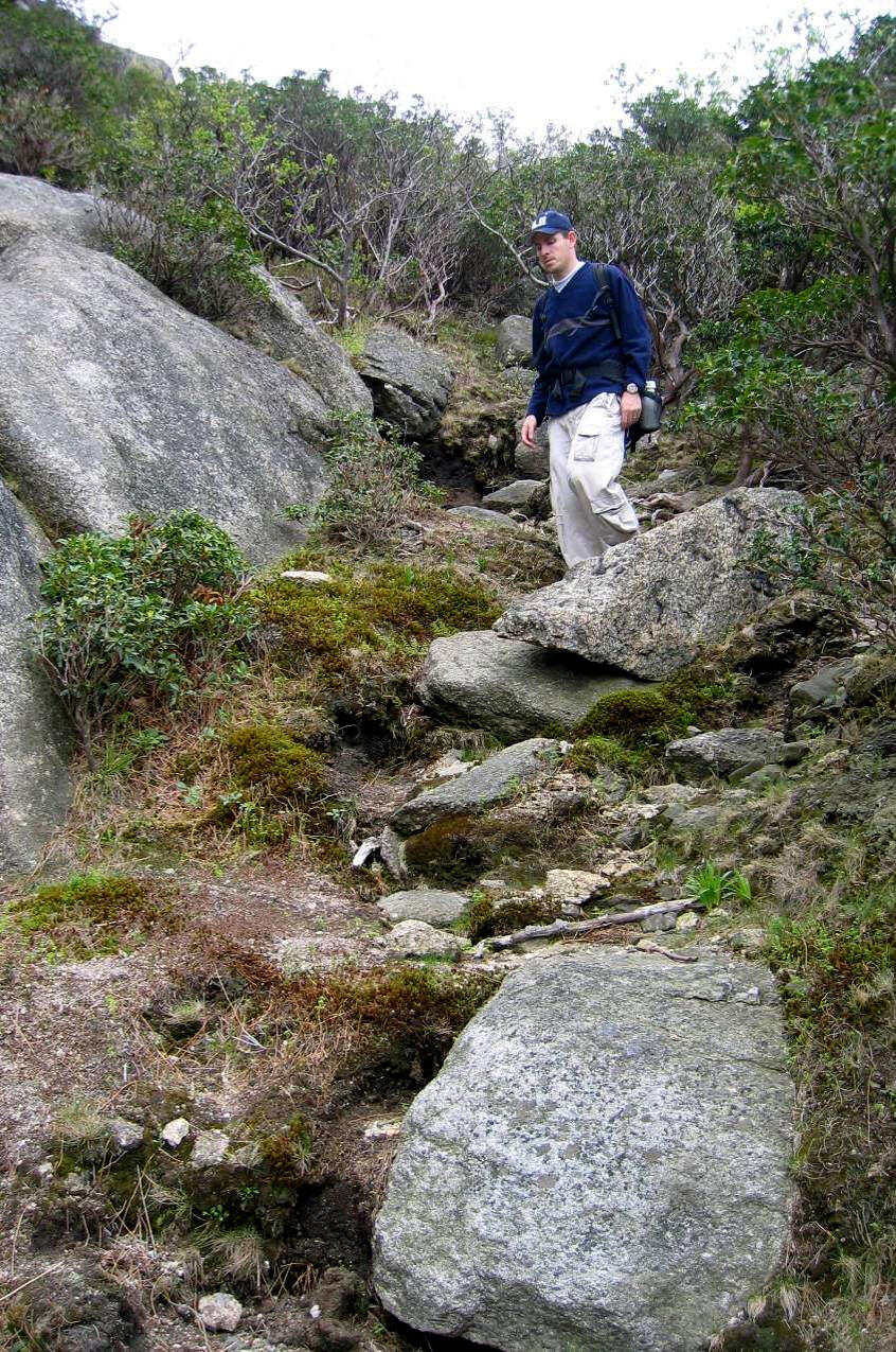 A visitor on a steep informal trail