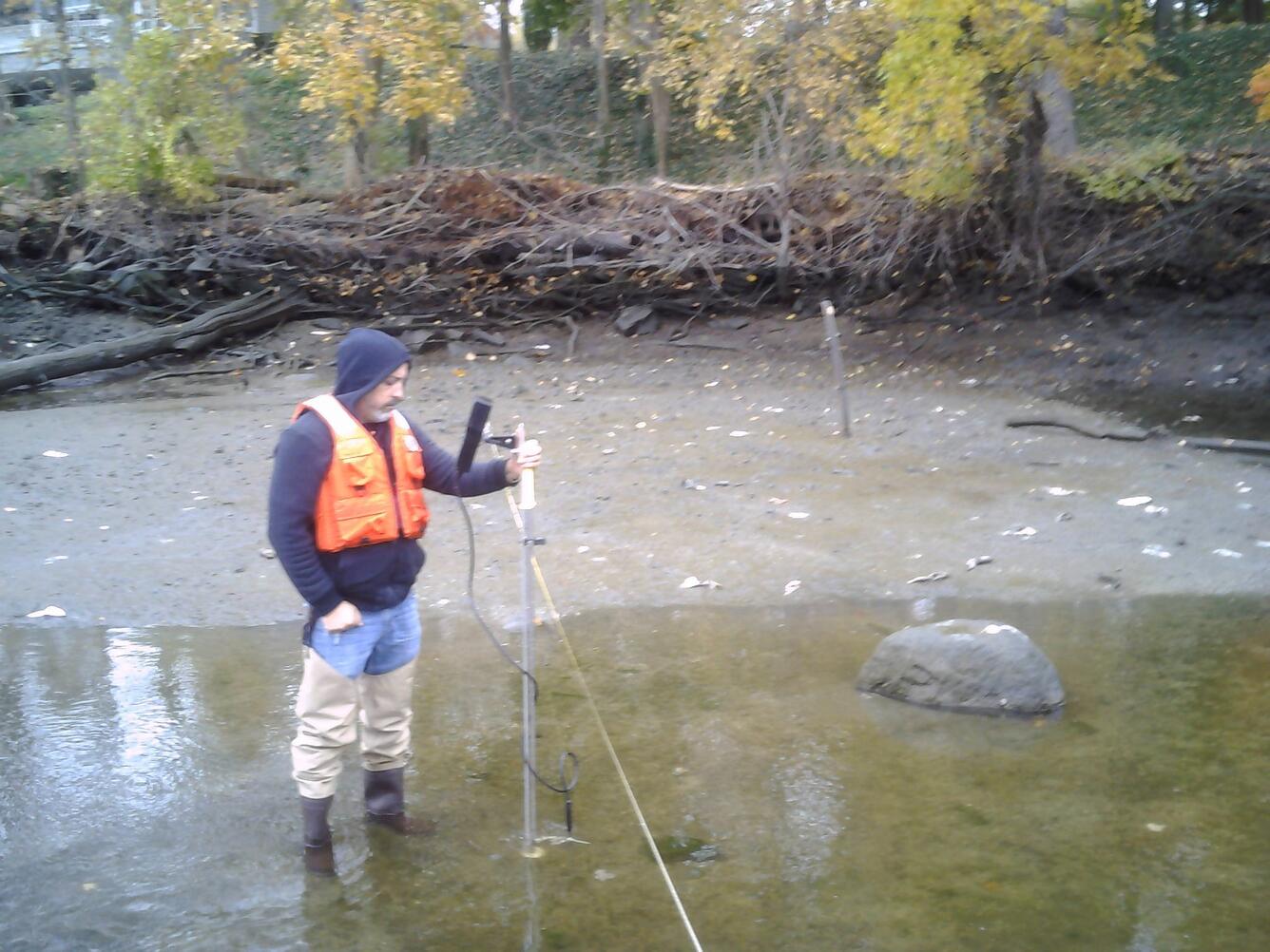 photo of Anthony cacace, hydrological tech taking stream flow measurements