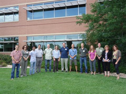 Powell Center working group (13 people) standing on grass outside the Fort Collins Science Center