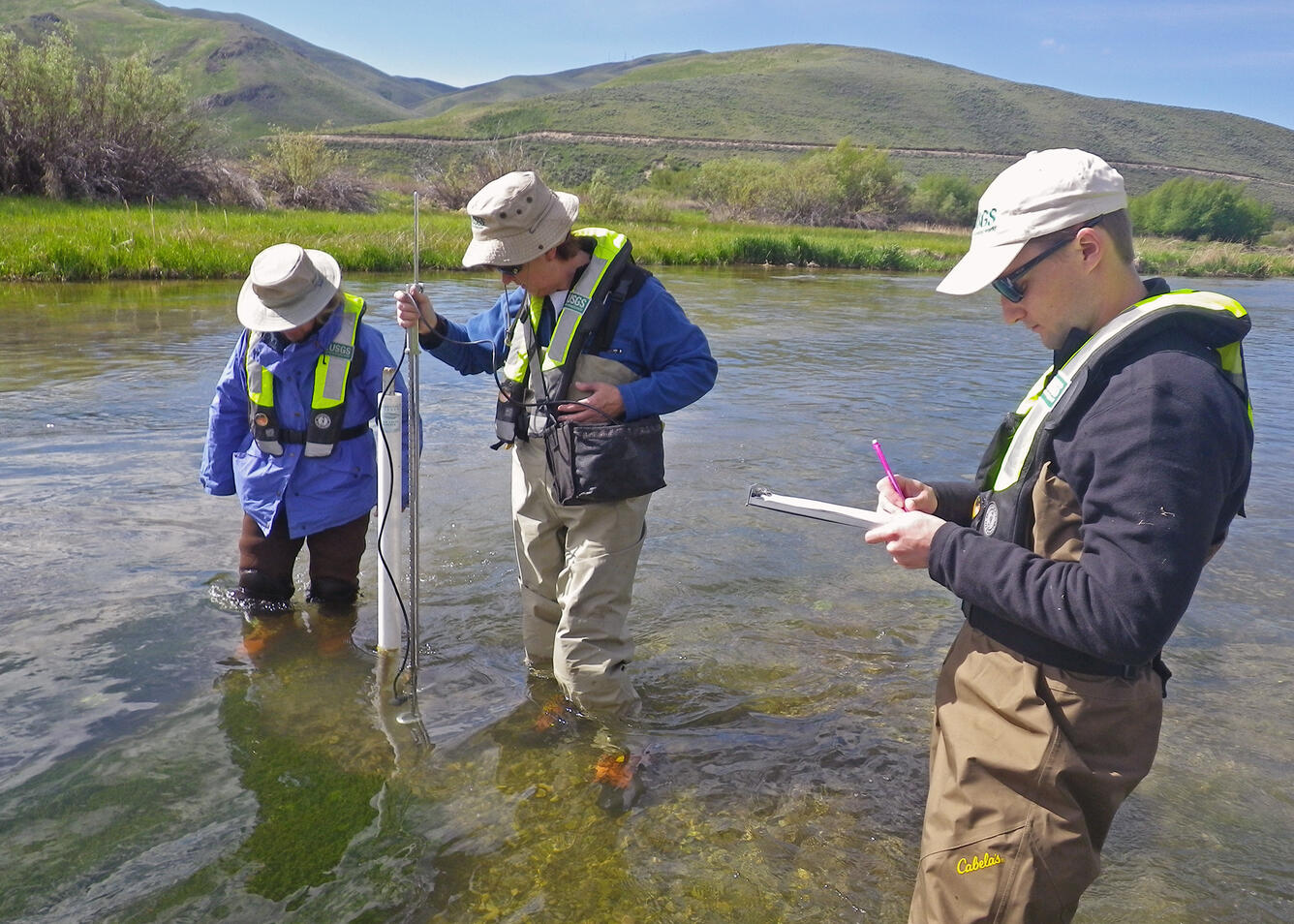 Scientists measuring depth and flow on Silver Creek, Idaho