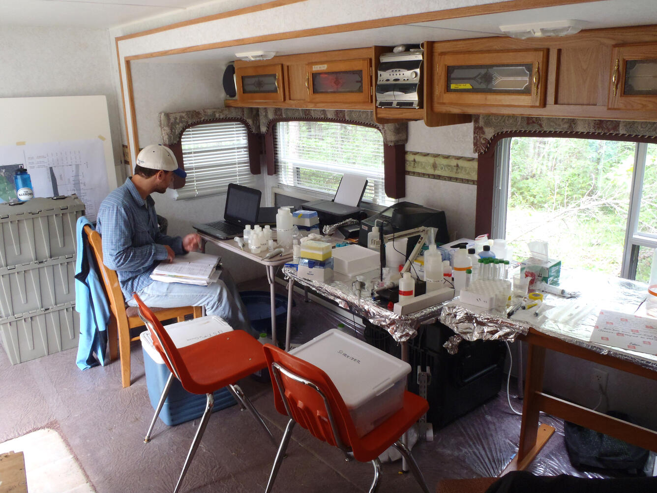 Photo of a USGS scientist analyzing samples inside a mobile lab