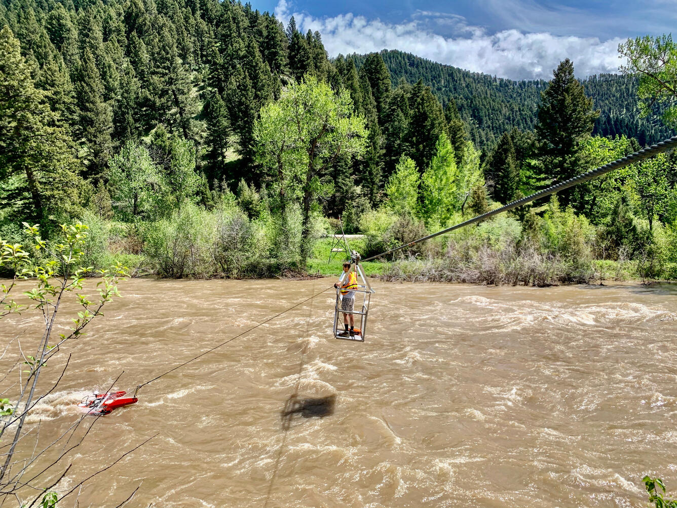 Cody Lanpher making a high flow measurement during a snow melt event on the Gallatin River near Gallatin Gateway, MT.