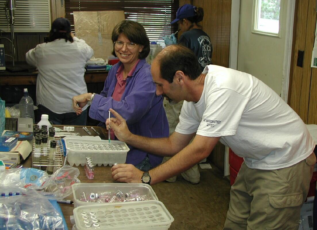 USGS scientists inoculating microbial growth media to determine the number and type of microorganisms