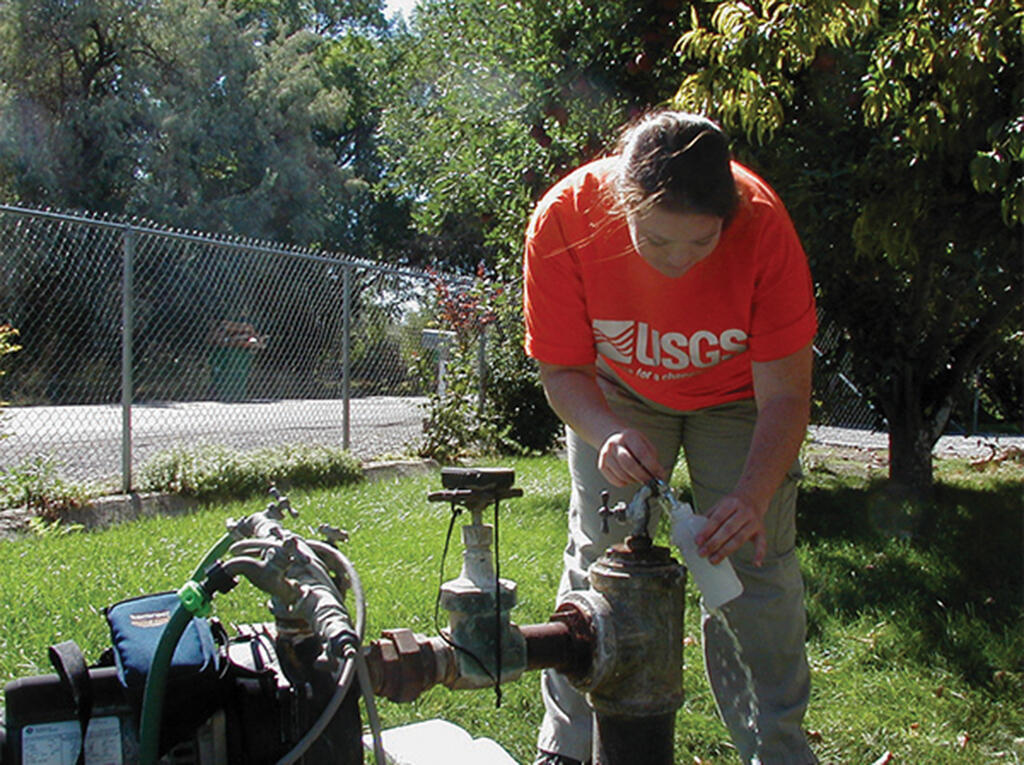 USGS employee sampling a groundwater well