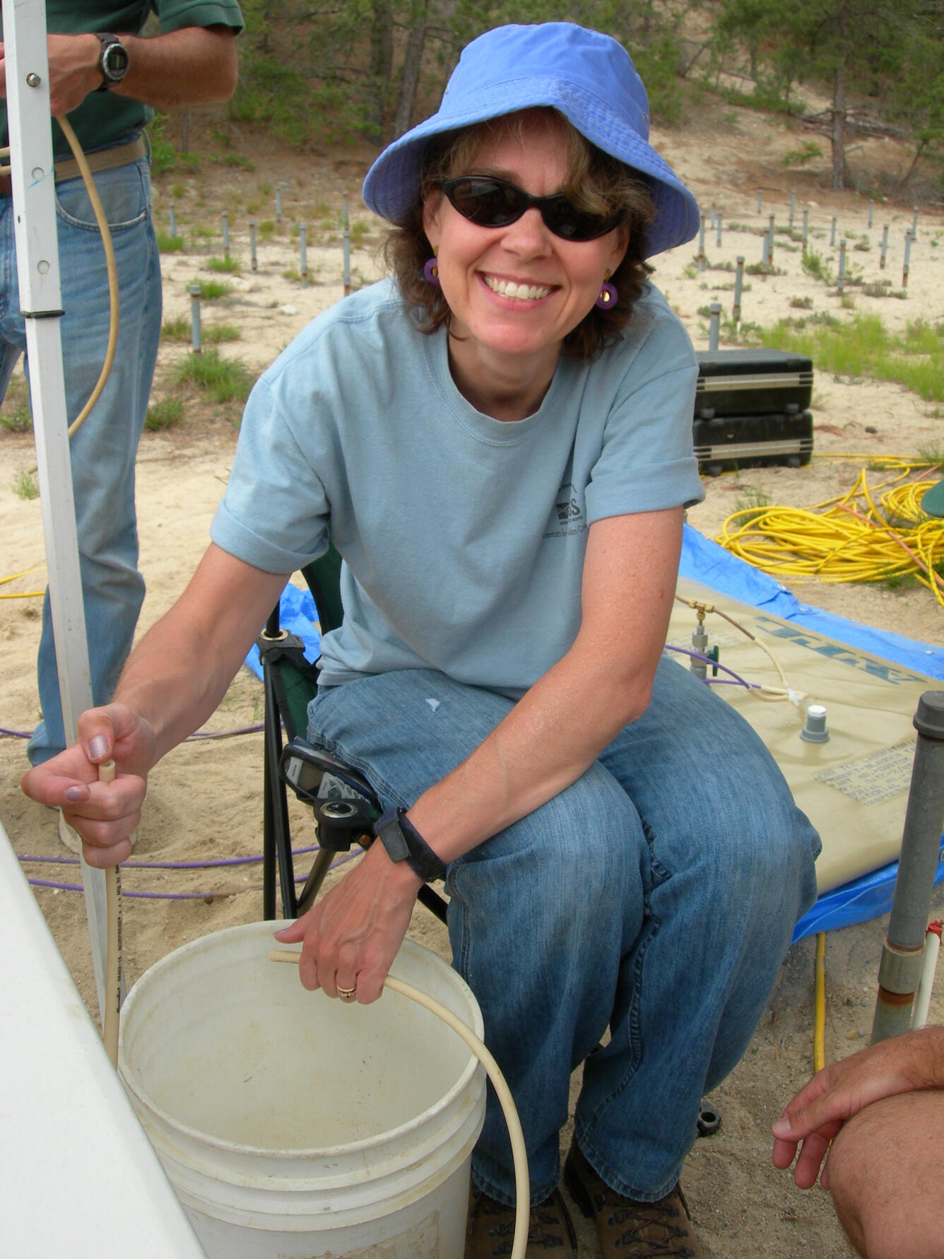 USGS scientist collecting a groundwater sample at the Cape Cod site