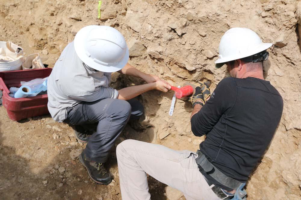 Scientists take a sample for OSL dating from trench wall