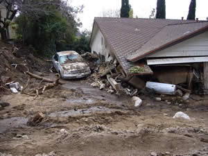 house surrounded with mud up to the roofline