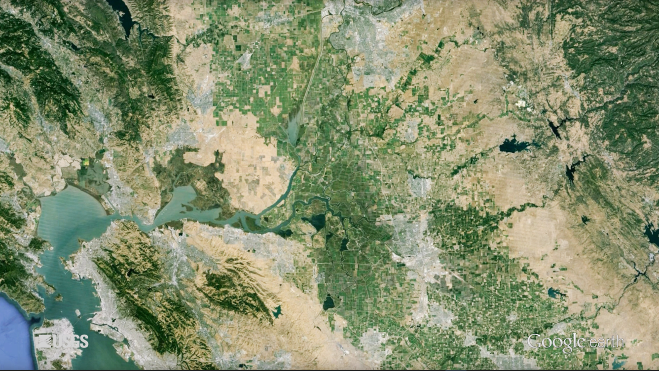 Satellite image of a large bay, the surrounding land, and the rivers that feed the bay.