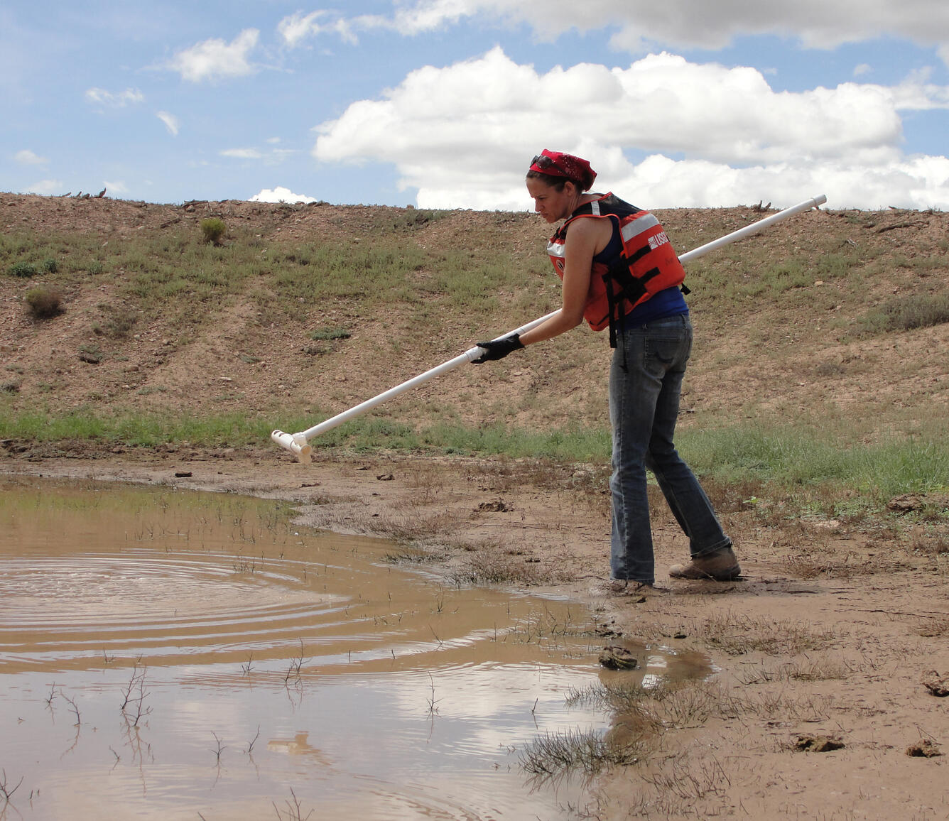 Biologist collecting water samples for environment DNA analysis