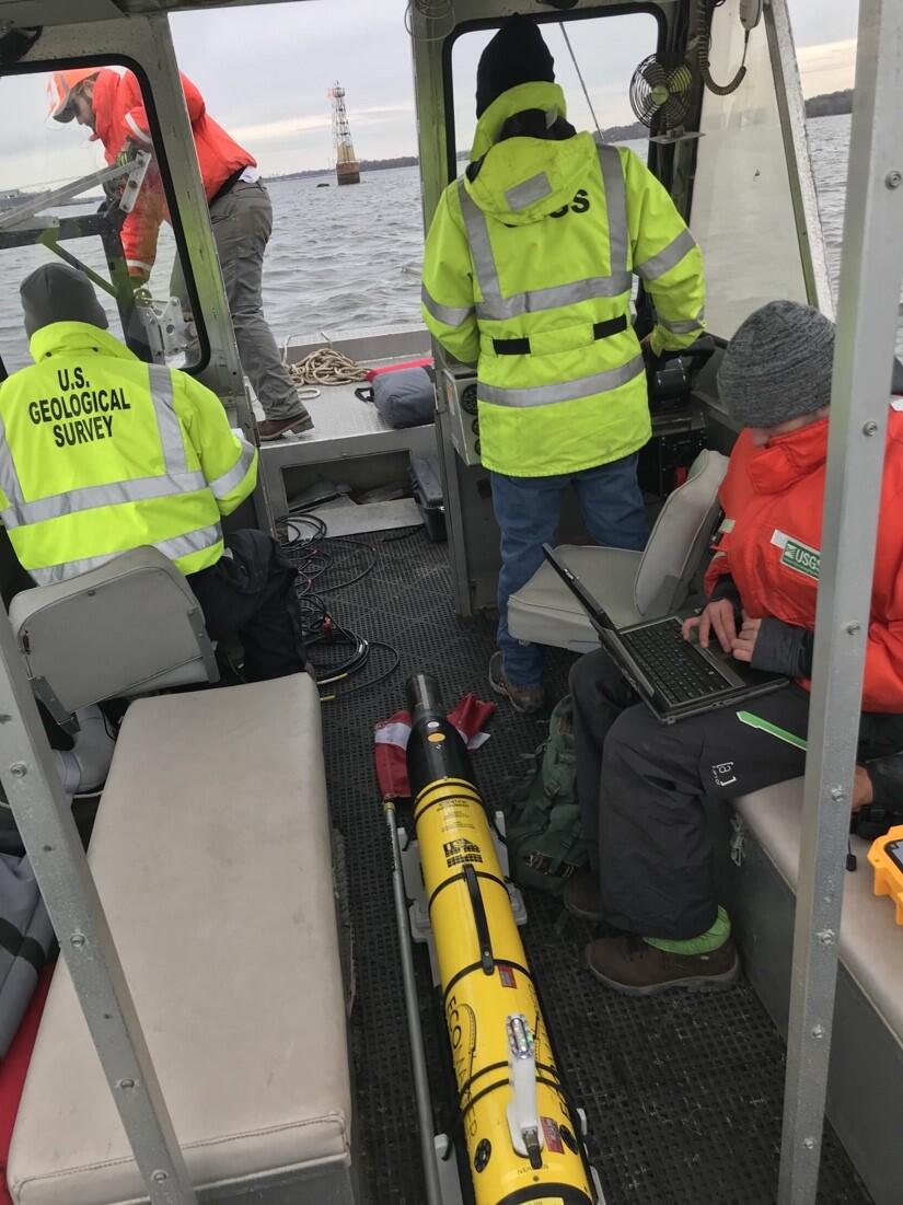 Photo of an Ecomapper autonomous underwater vehicle (AUV), and USGS crew