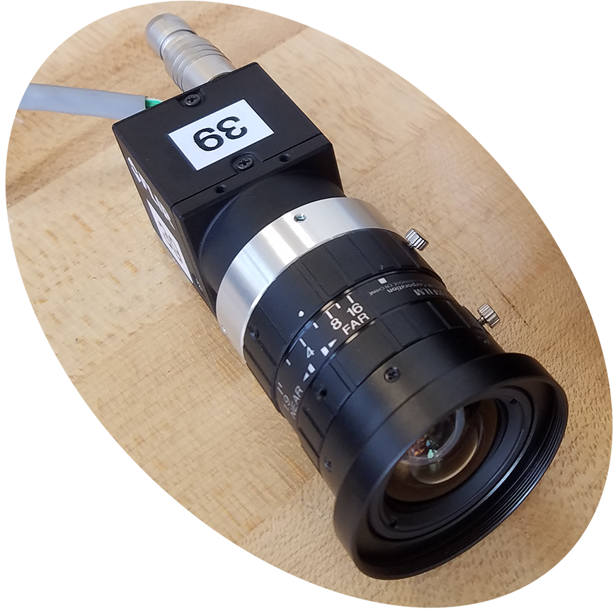 Photograph of a square camera housing with a long lens attached.