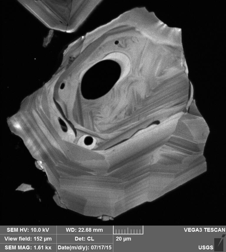 Image shows a scan of a zircon on a black background