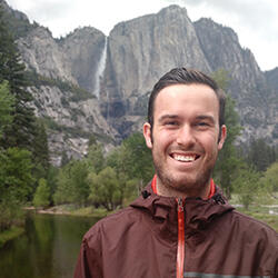 Photo of hydrologist Riley Gannon with Yosemite Falls in background