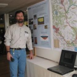 Photo of Hydrologist Henry Zajd next to poster